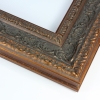 This large bronze with black Parisienne frame features highly decorative details on a wide 3 " profile. This vintage frame gives off a luxurious classic look that can elevate any artwork.